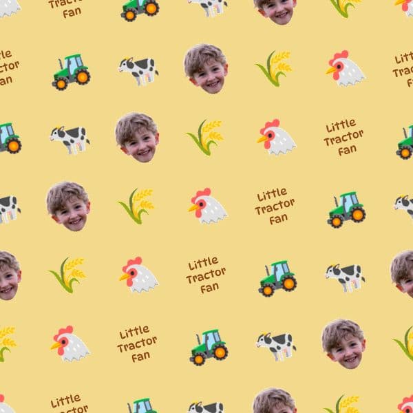 Wrapping paper with cartoon tractors and wooden barn signs on a warm hay-gold background