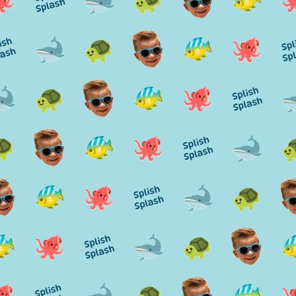 Aqua wrapping paper with cartoon whales, turtles and colourful fish and a child's name