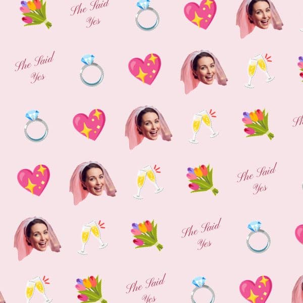 Blush pink wrapping paper with sparkling diamond rings, hearts, a smiling bride-to-be and flowing calligraphy