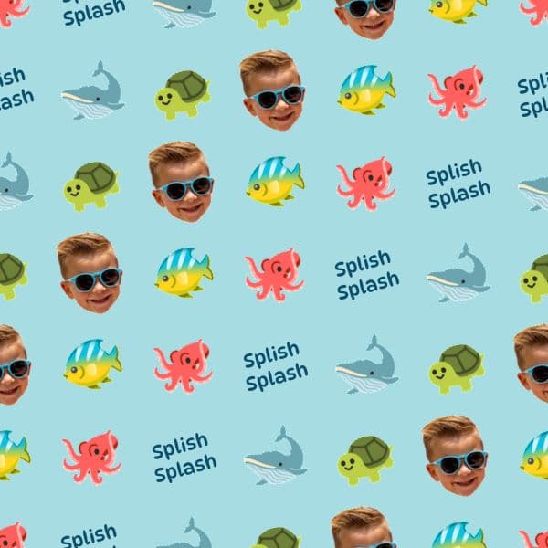 Aqua wrapping paper with cartoon whales, turtles and colourful fish and a child's name
